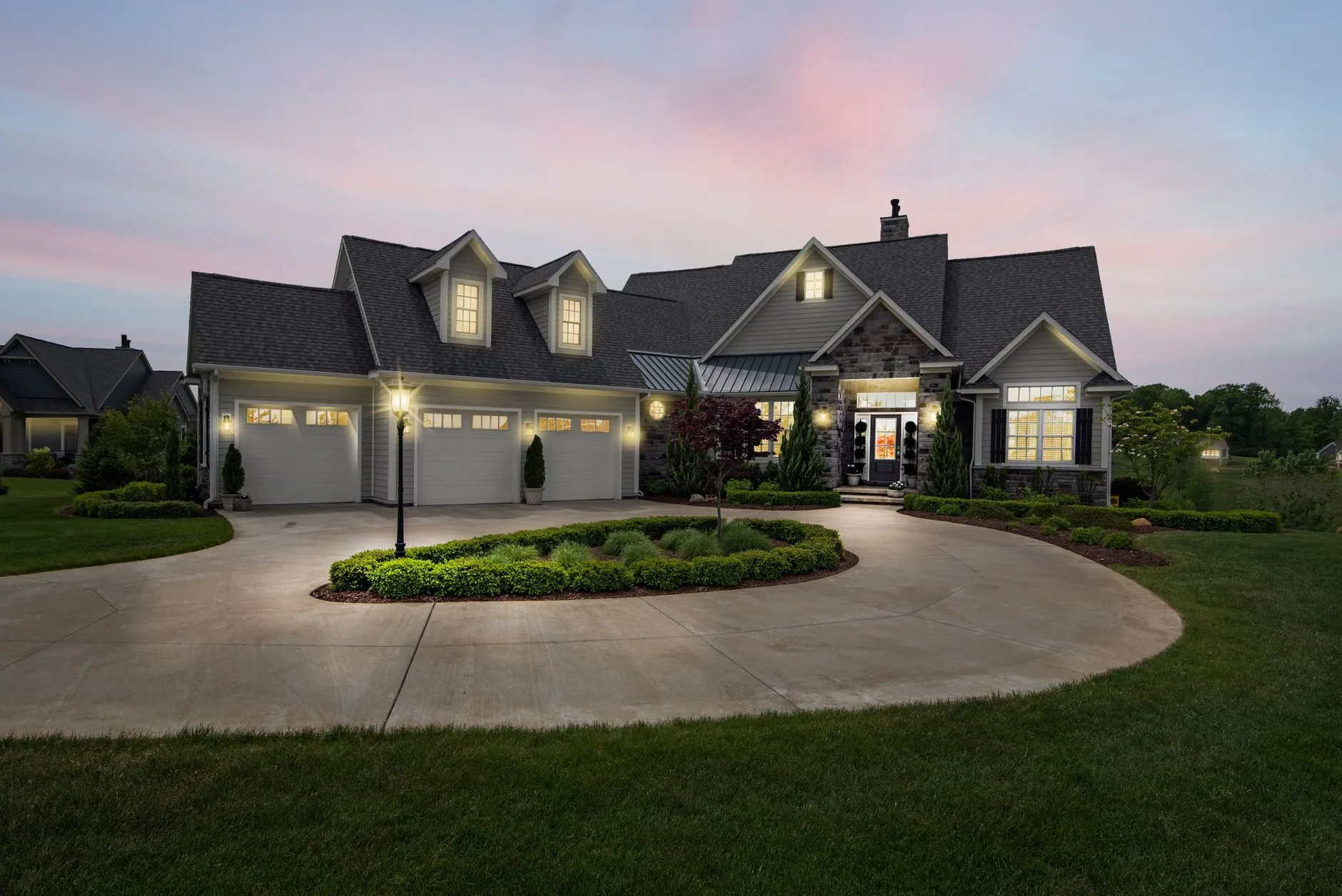A beautifully sided two-story home at dusk by Uhlmann Home Improvement